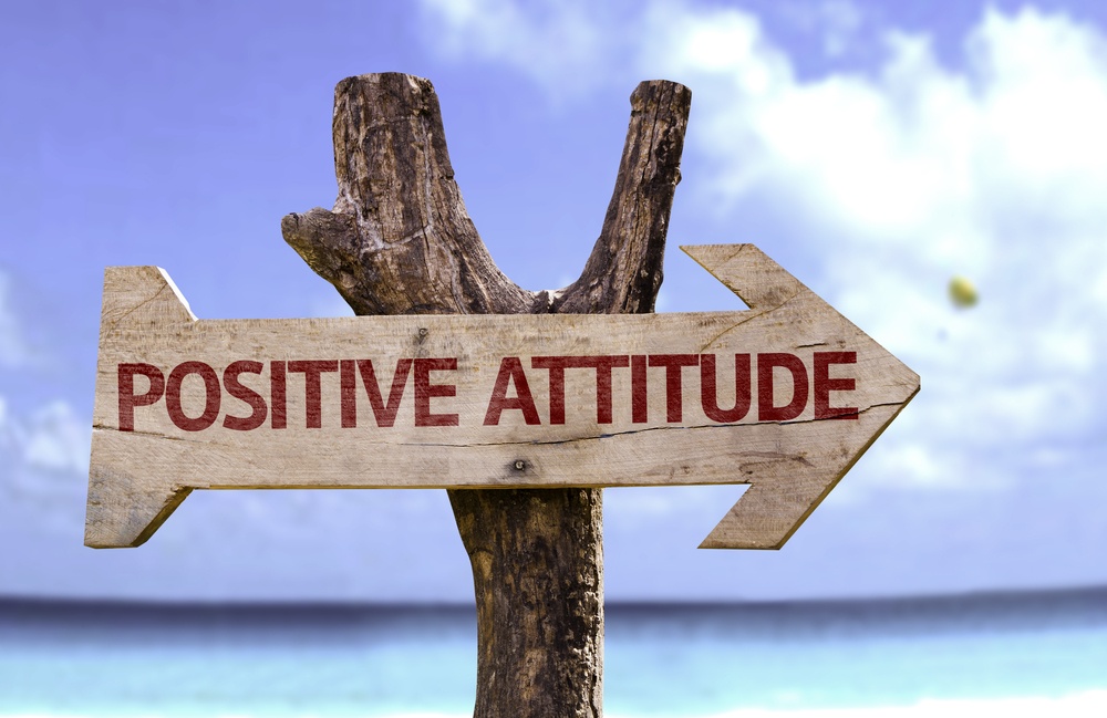 Positive Attitude wooden sign with a beach on background.jpeg